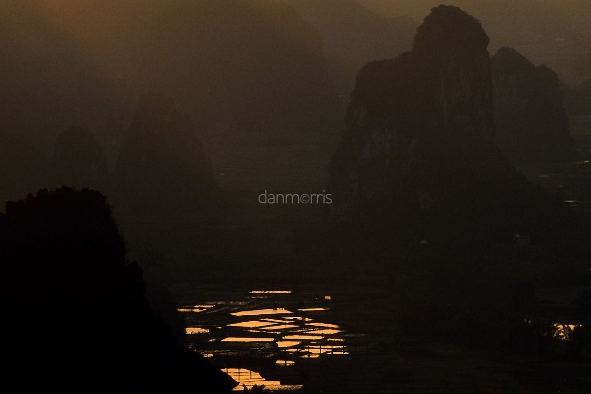 Yangshuo Sunrise Early morning light over landscape of rice paddies and myriad silhouetted karst towers, Yangshuo, Guilin, China (Dan Morris)
