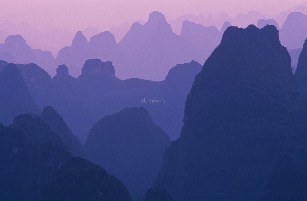Yangshuo Sunrise Sun rises over landscape of myriad silhouetted karst towers, Yangshuo, Guilin, China (Dan Morris)